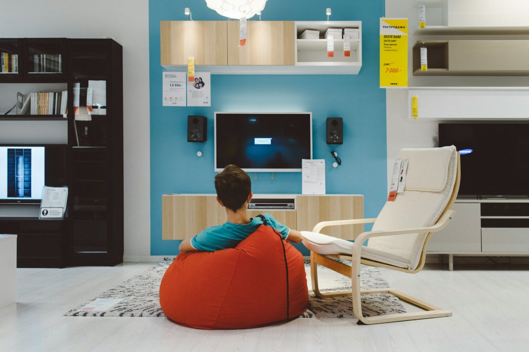 person sitting in a living room equipped with a bunch of smart furniture